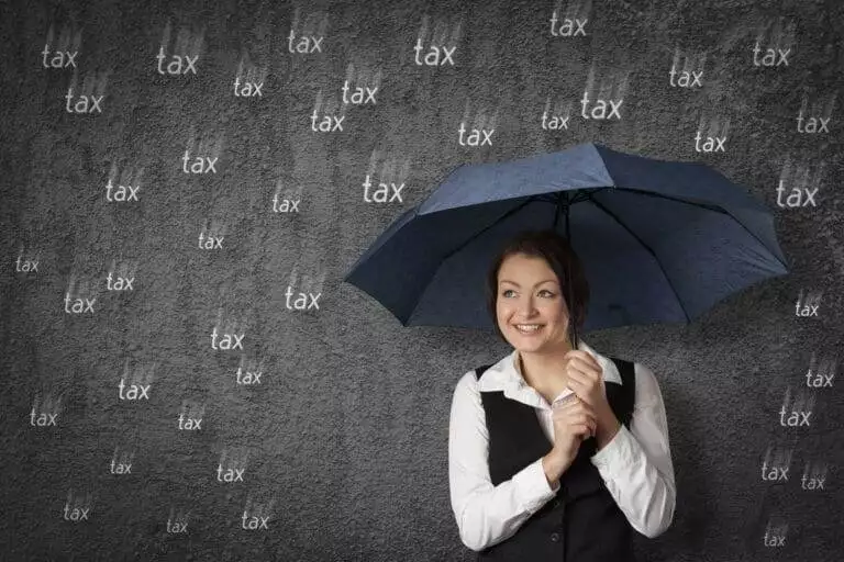 Accountant woman get cute with tax. Sly businesswoman hide and protect herself under umbrella against raining tax. Tax optimization concept.